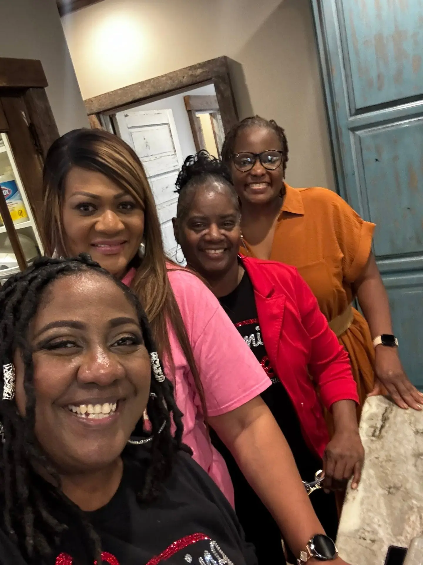 Four women from the ministry smiling together in a candid group photo.