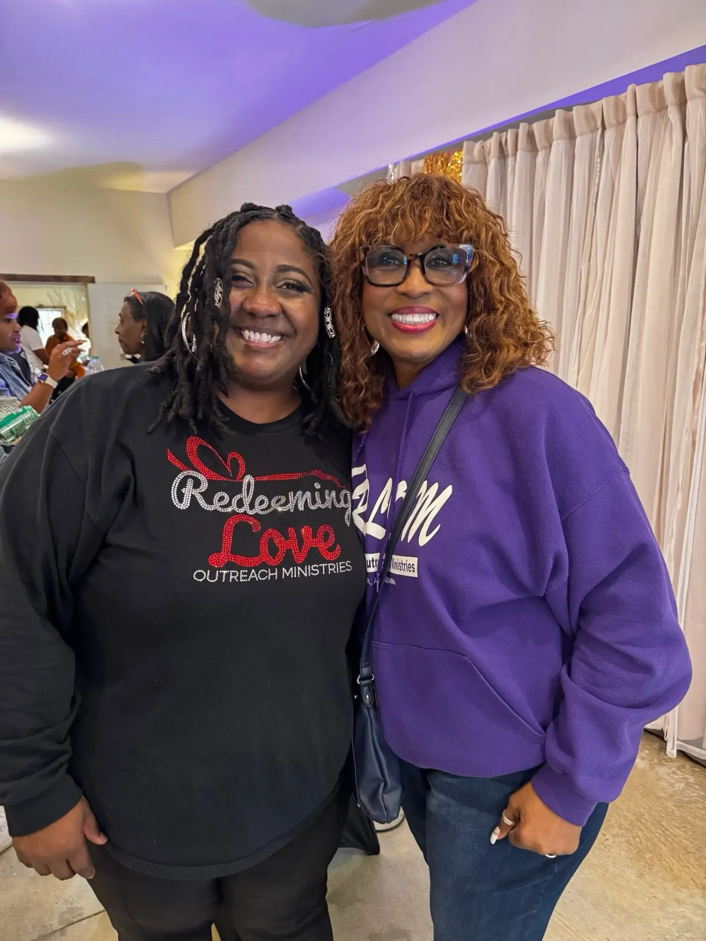Rose Sherrod smiling with Pastor Emma White at a Redeeming Love Outreach Ministries event.
