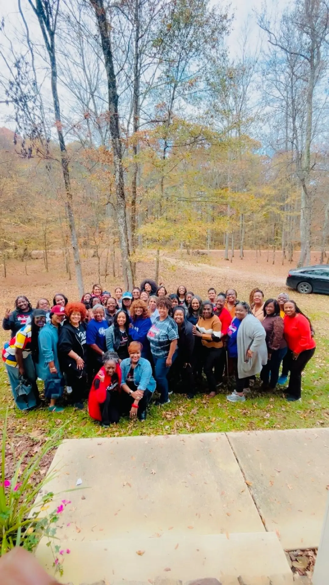 Large outdoor group photo of the women's ministry gathered together on a fall retreat.